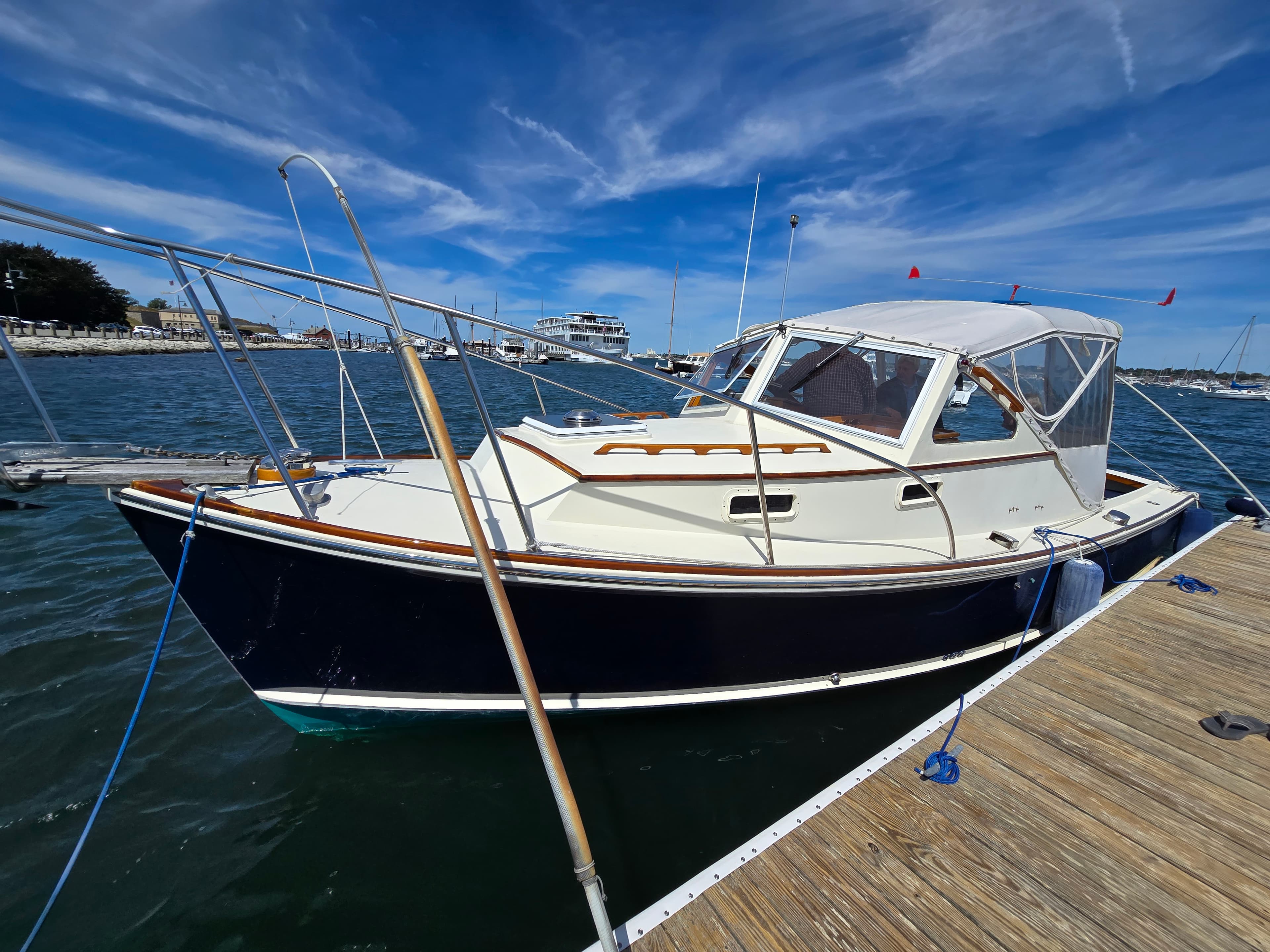 A navy-hulled downeast boat kept ready at her berth on Narragansett Bay
